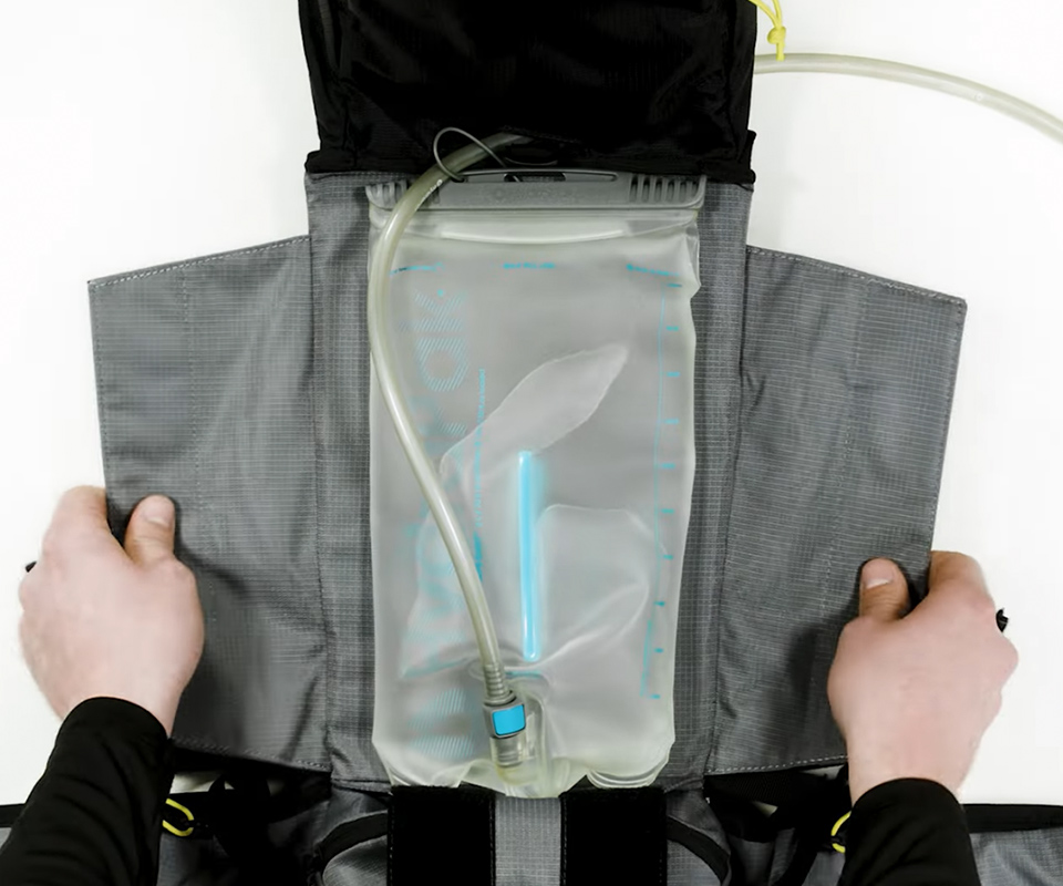 Hydration reservoir storage integrated into technical backpack