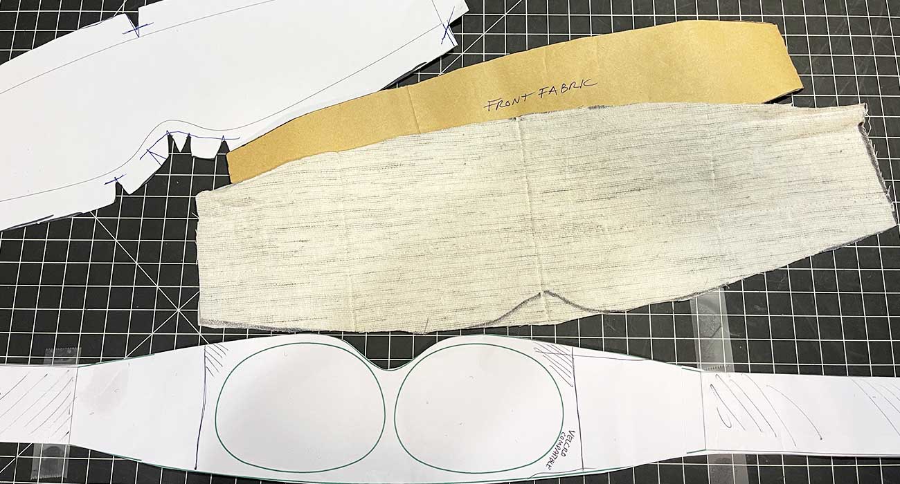 Soft goods factory sample maker constructing a backpack using manufacturing documentation