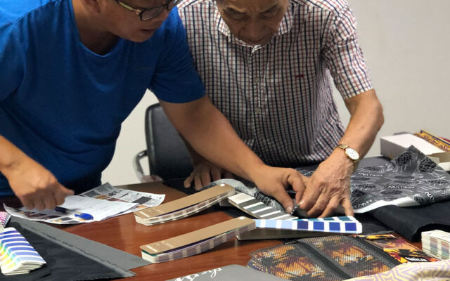 Factory reviewing an incomplete soft goods design while a designer finalizes product architecture.