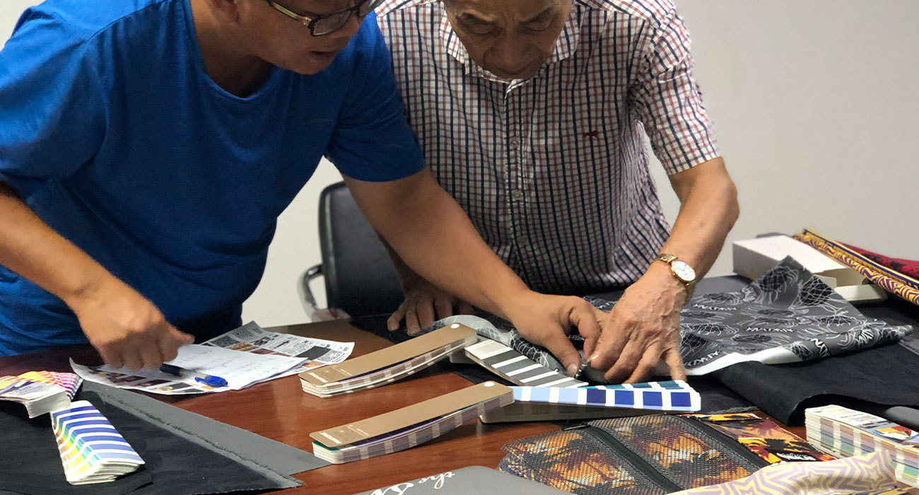 Factory reviewing an incomplete soft goods design while a designer finalizes product architecture.