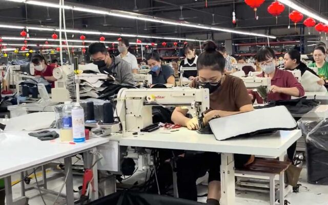Product designer reviewing soft goods prototypes with manufacturing samples during product development