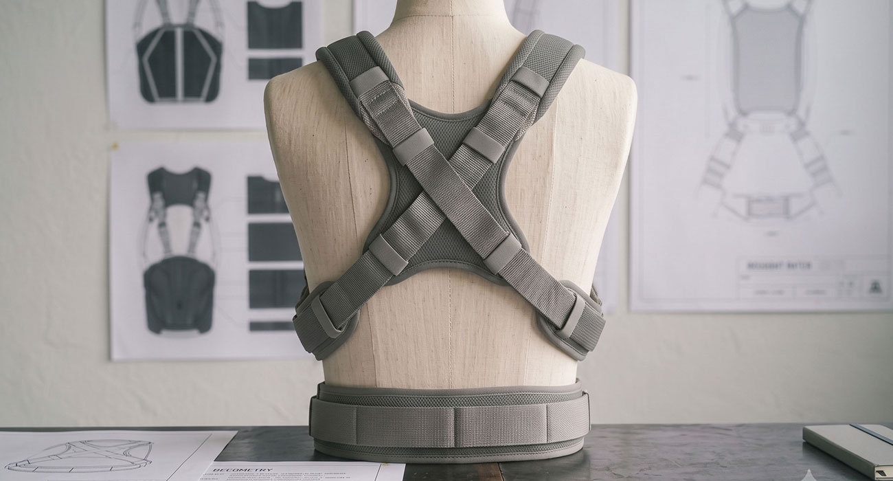 Engineer reviewing scalable soft goods product design featuring construction details, materials, and manufacturing considerations for a premium sewn product.